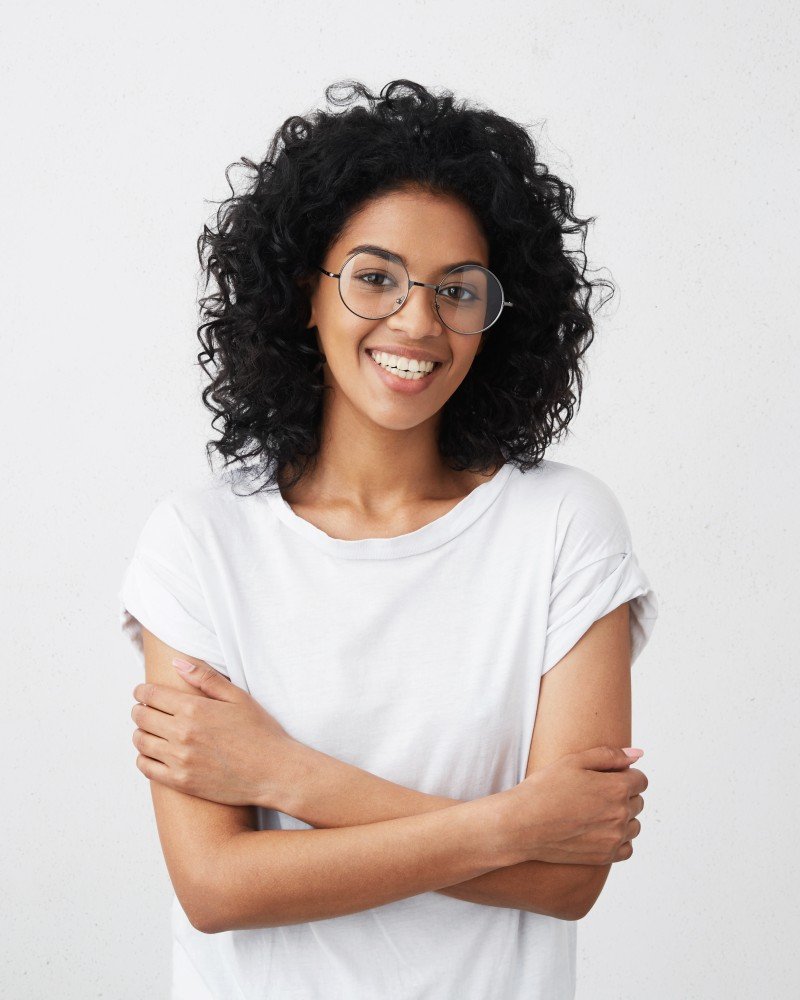 Home indoor shot beautiful happy african american woman smiling cheerfully keeping her arms folded relaxing indoors after morning lectures university 1.jpg